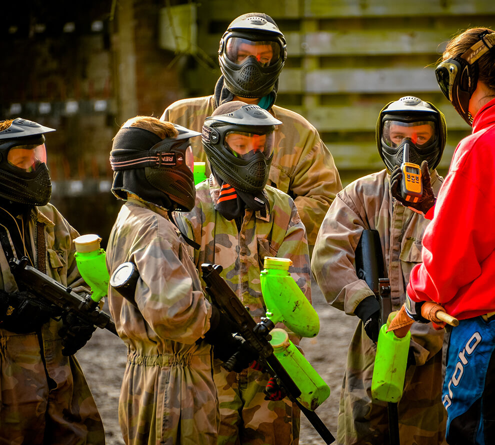 A young group waiting to go out onto a paintball course