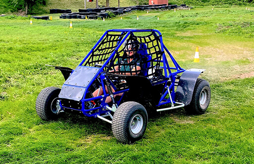 A couple of go karts driving around a track