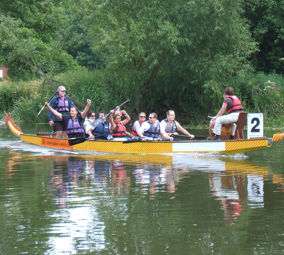 A group celebrating after winning a rowing competition