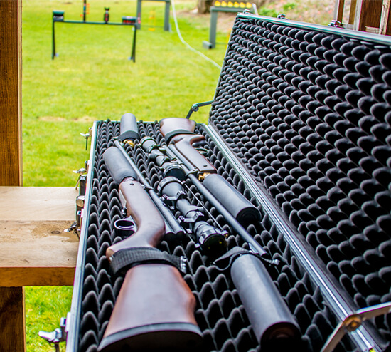 A close up of a man aiming down a rifle scope