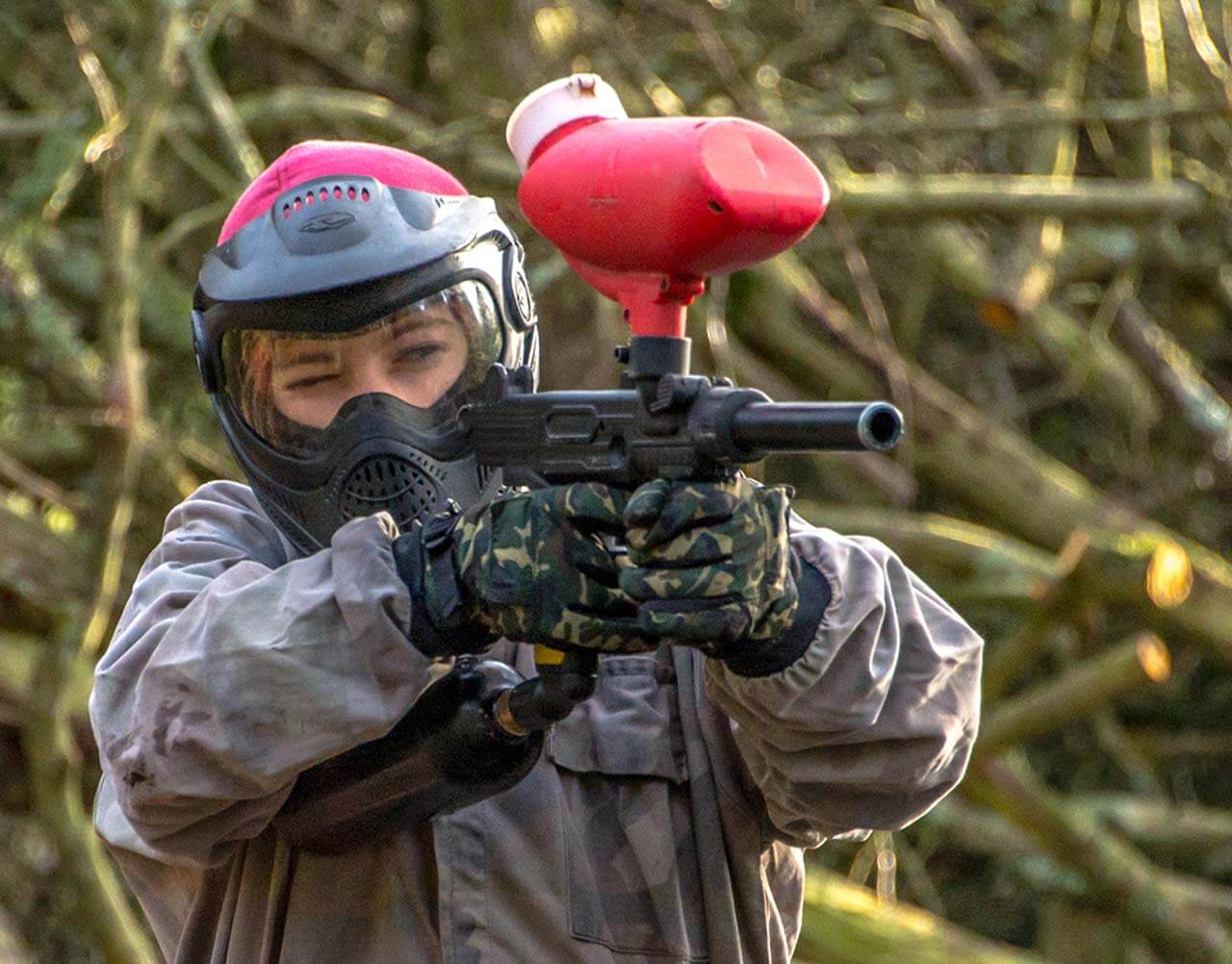 Someone aiming a paintball gun