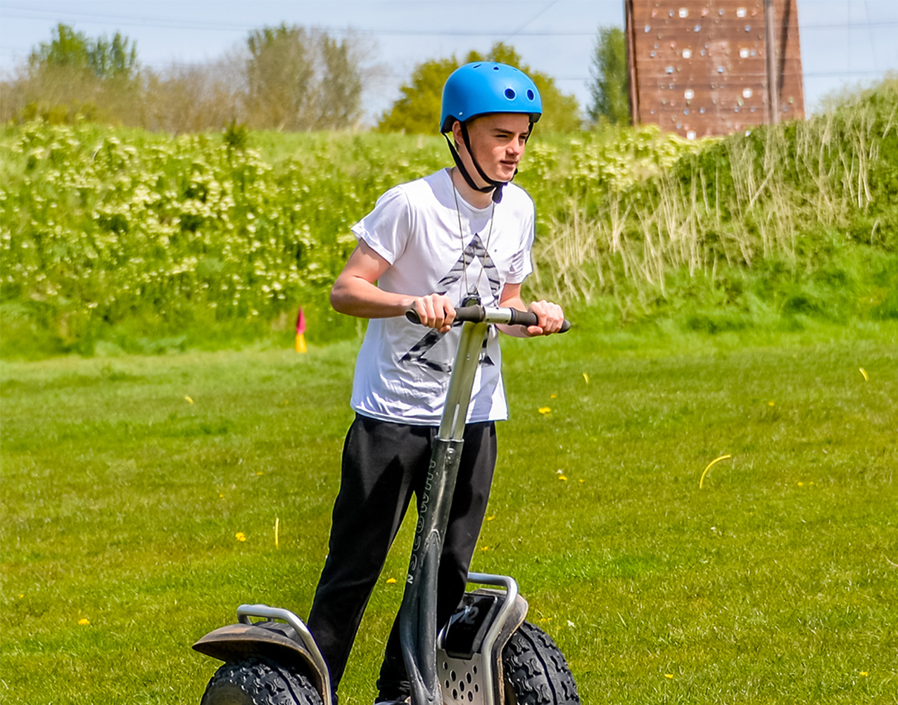 A boy riding a segway